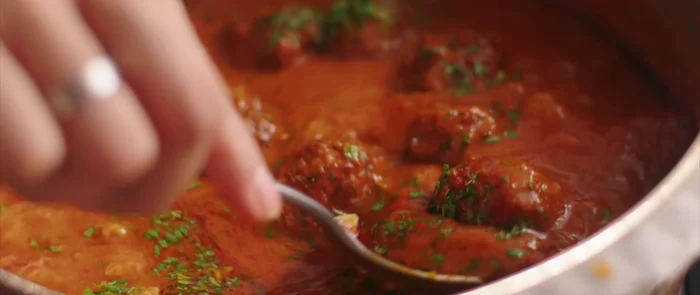 Add the fried koftas and chopped coriander to the gravy. Simmer on low flame for a few minutes to heat through.
