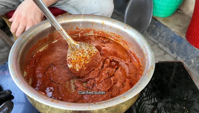 Stir in beaten curd and cook until it boils well.