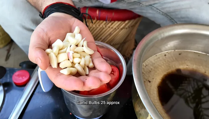 Grind tomatoes, ginger, garlic, and Kashmiri chilies into a paste.