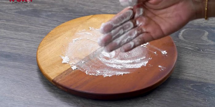 Take a portion of dough, roll it out slightly. Fold the dough as shown in the video.