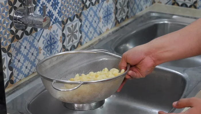 Drain macaroni, rinse with cold water for a crispy texture.