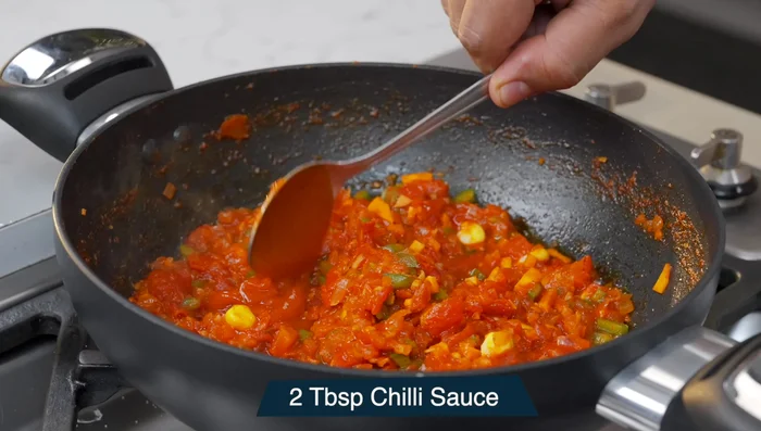 Add sausages, chili sauce, tomato ketchup, and Schezwan sauce (optional).