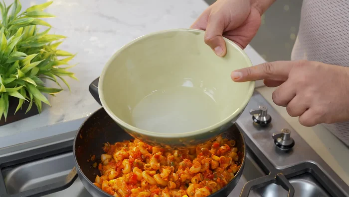For a thicker sauce, add the macaroni and the reserved macaroni water to a pan and cook until thickened.