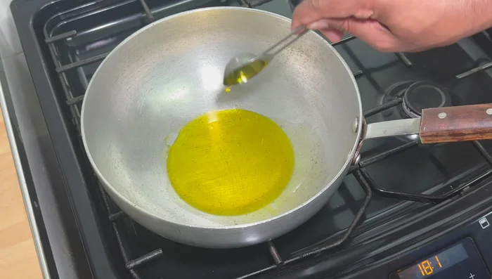 Heat mustard oil in a pan. Add the chicken and cook for 2-3 minutes per side until a crust forms. Remove the chicken and set aside.