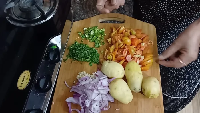 Finely chop onions, garlic, green chilies, and coriander.