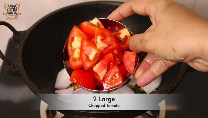 Add chopped onions and tomatoes. Cook until soft.
