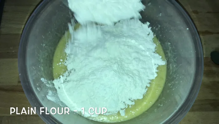 Incorporate 1/2 cup of flour, 1 tablespoon baking powder, and 1 teaspoon baking soda.