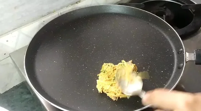 Heat a pan. Take a spoonful of batter and spread thinly on the pan.