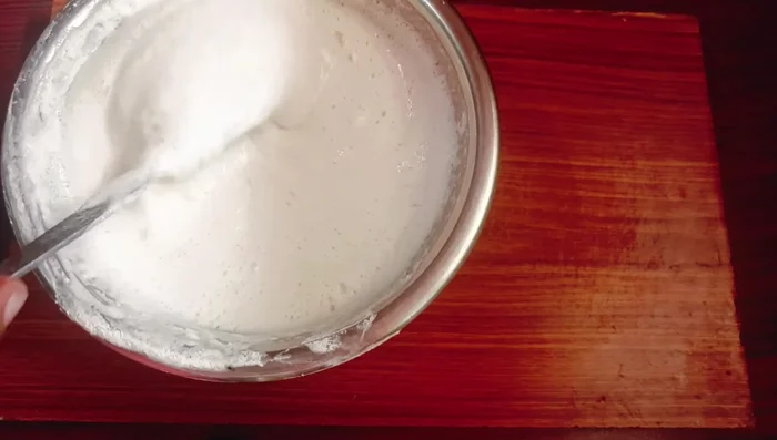 Prepare idli batter the night before using urad dal and rice. Let it ferment overnight.