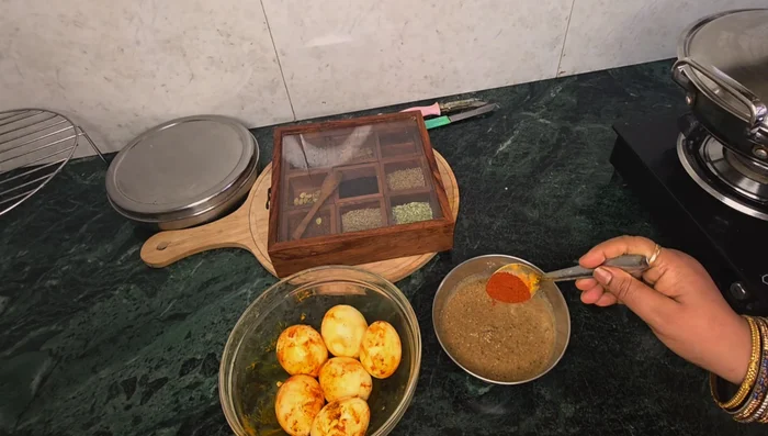 Prepare the eggs: Add salt, turmeric, and red chili powder.