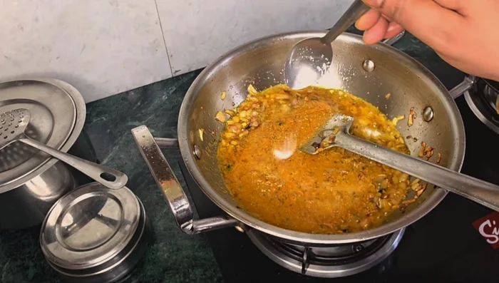Add the spice mixture (soaked coriander, cumin, ginger-garlic paste) and salt.