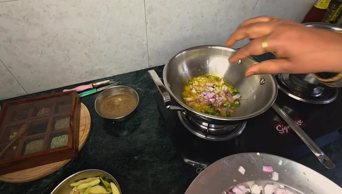Fry the pointed gourd and potatoes. Add turmeric and salt.