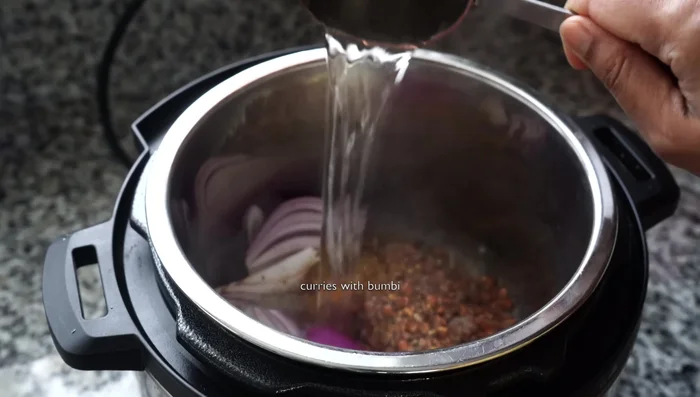 Add 2 cups of hot water and a small tomato. Pressure cook for 12 minutes.