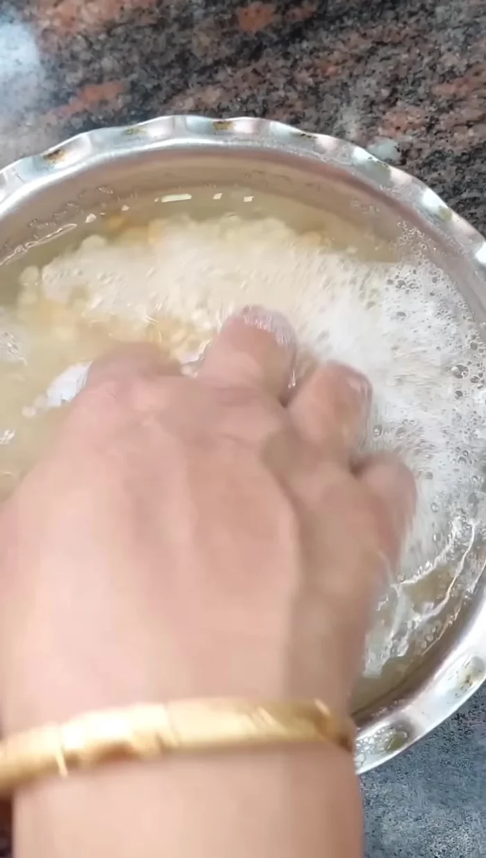 Add fenugreek seeds and mix. Take out soaked mash dal (7:00 am), drain water, add ½ spoon of water to make a paste.