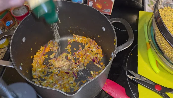 Stir in coriander, ground ginger, cumin, curry powder, smoky paprika, red pepper flakes, salt, and pepper.