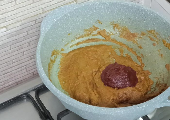 Add tomato paste and sauté well. Add water to create a gravy, adjust salt to taste.