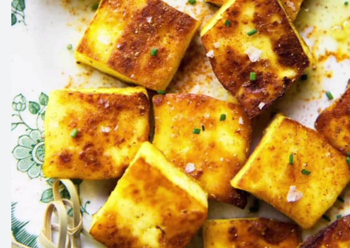 Fry paneer cubes in coconut oil. Boil green peas with salt and turmeric powder.