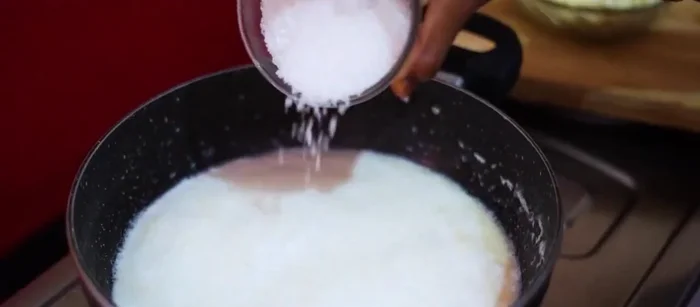 Add sugar to the boiling milk and stir until dissolved.