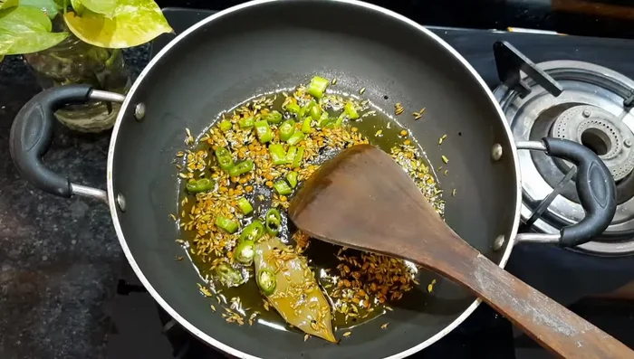 Add chopped green chilies and fry for 1 minute.