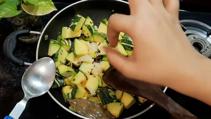 Add crushed garlic (optional), salt, and mix well.