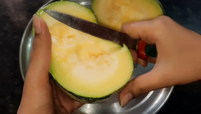 Cut the pumpkin into two parts, then into long pieces. Remove the thick, hard seeds.