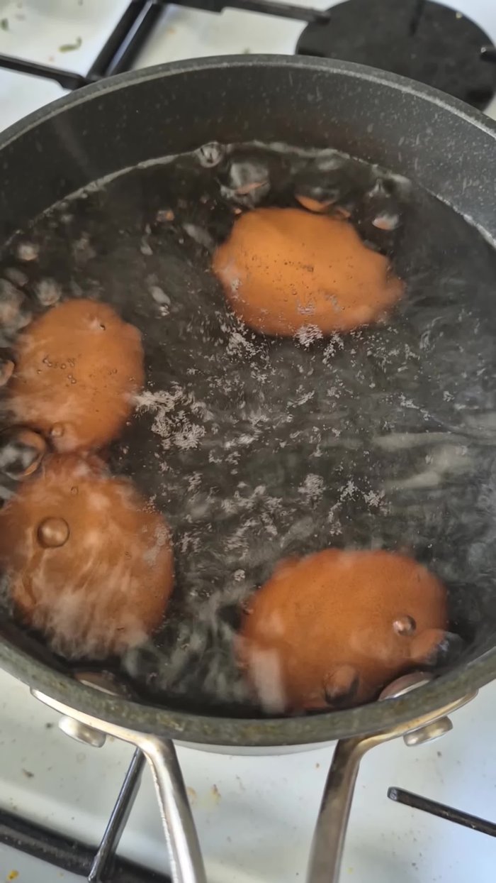 Boil eggs until cooked through.