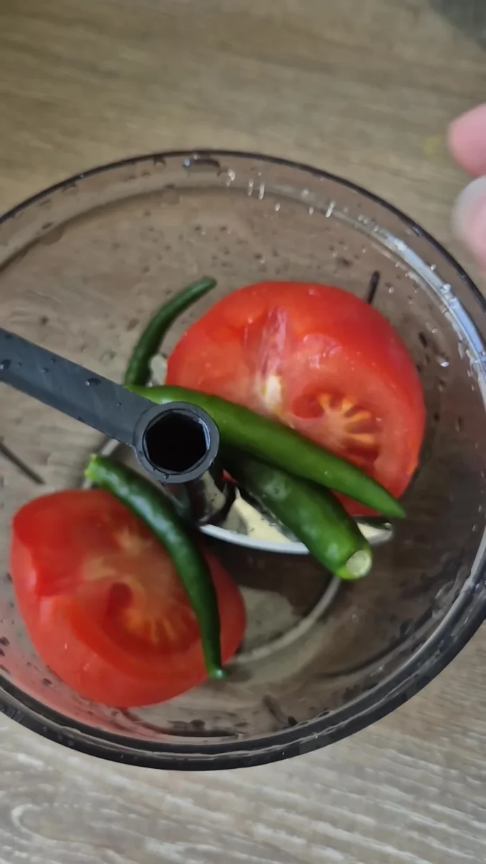 Chop one ripe tomato and a few green chilies.