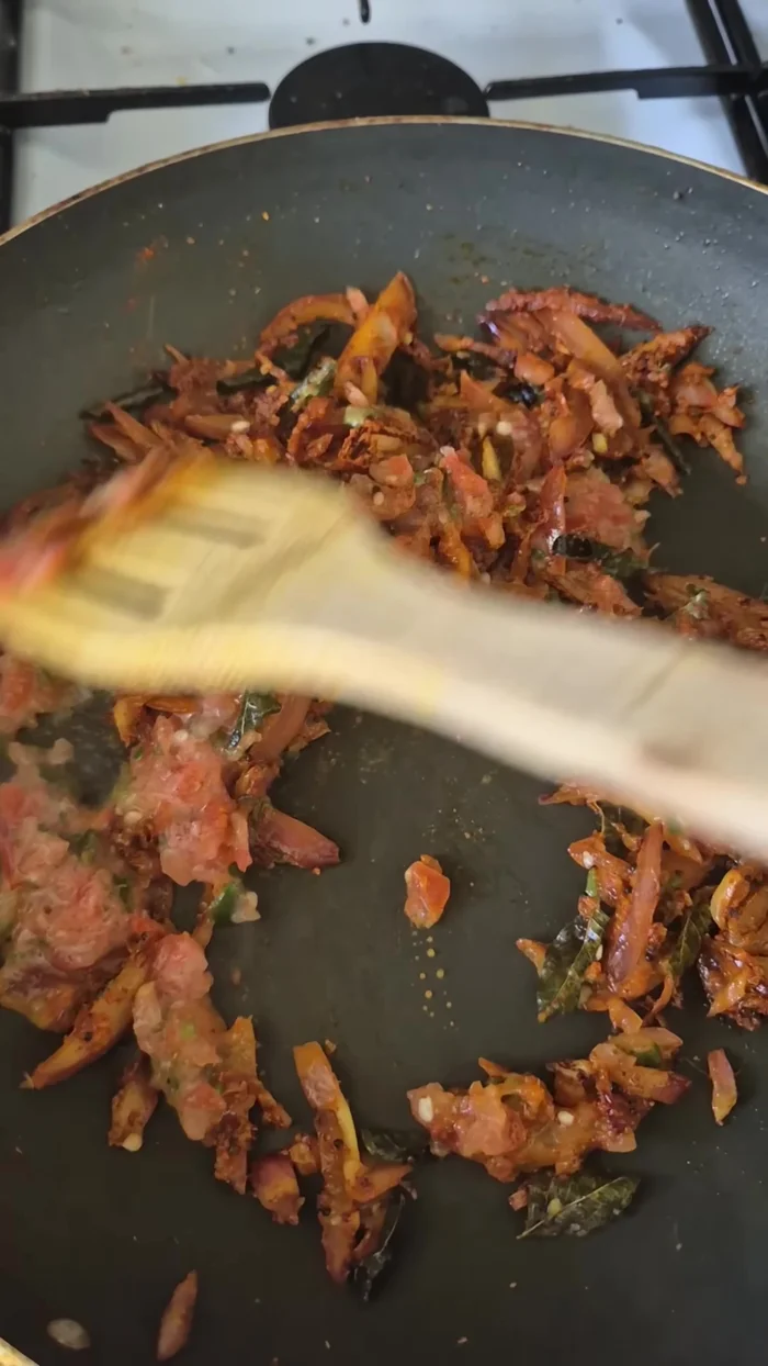 Add the chopped tomatoes and chilies to the pan and mix well.
