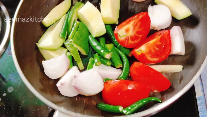For the raw mango chutney: Heat oil in a pan. Add chopped raw mango, onion, chili, and tomato (optional). Roast until softened.