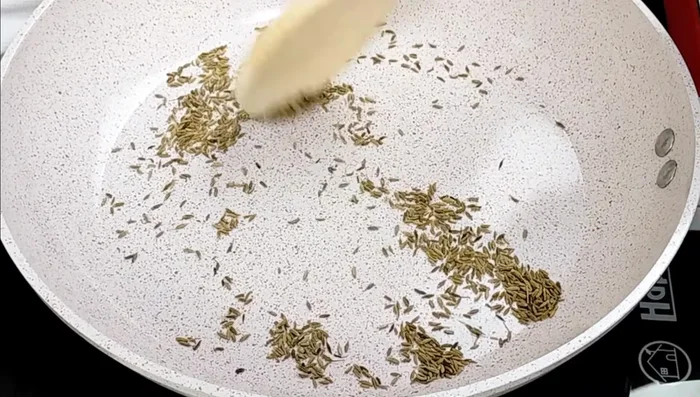 Dry roast the white cumin seeds until fragrant. Grind them coarsely.