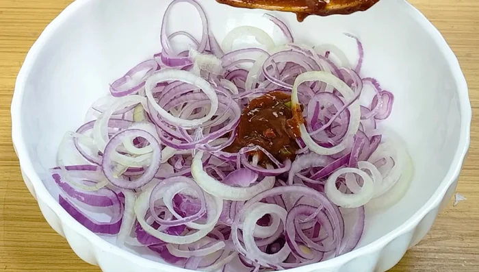 Add the spice mixture to the dried onion slices. Gently toss to coat the onions evenly with the spices.