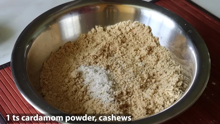 Once lukewarm, add 1 teaspoon of cardamom powder and the roasted cashew nuts.