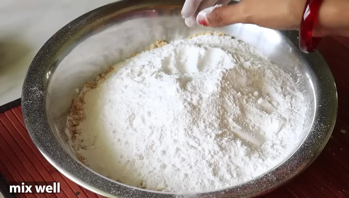 Add 2 cups of powdered sugar (or 3 cups of local sugar). Mix well using hands or spoon until well combined.