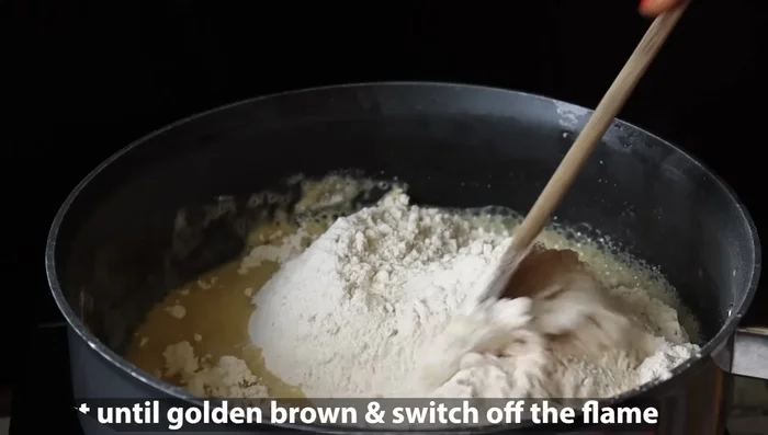 Remove cashew nuts and set aside. Add the 3 cups of wheat flour to the ghee in the pan. Fry on low flame until golden brown, stirring frequently. This will take some time; the aroma will indicate it's ready.