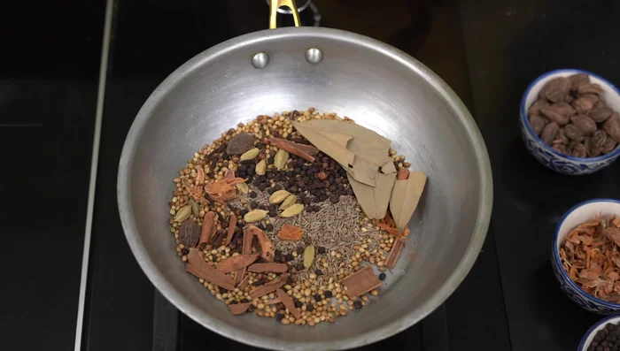 Remove the spices from the heat and let them cool completely on a plate before grinding. Grinding hot spices can cause them to burn.