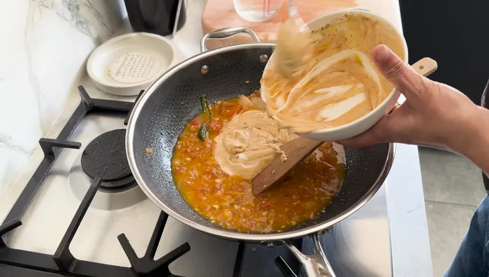 Add the yogurt mixture to the tomatoes, stirring gently. If needed, add a little more water to prevent splitting. Turn the heat back on very low.