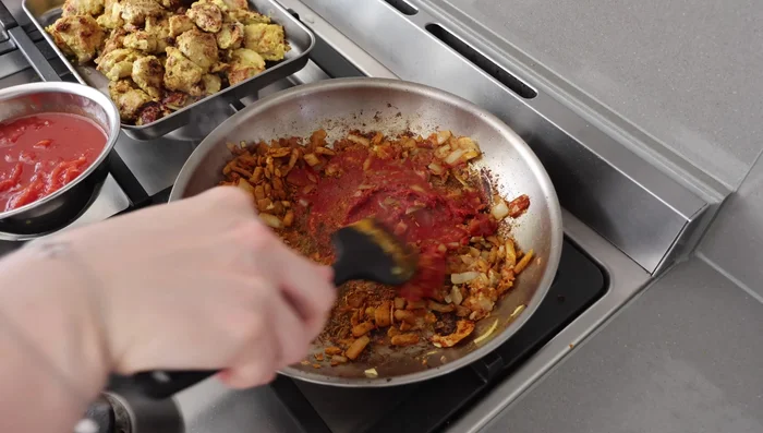 Simmer Sauce: Add concentrated tomato and crushed tomatoes. Cook for about 5 minutes, then add the cooked chicken. Add water or broth, and simmer for 15-20 minutes until the chicken is tender.