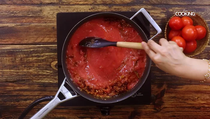 Add tomato puree and cook until the raw smell disappears and oil separates (about 15 minutes).