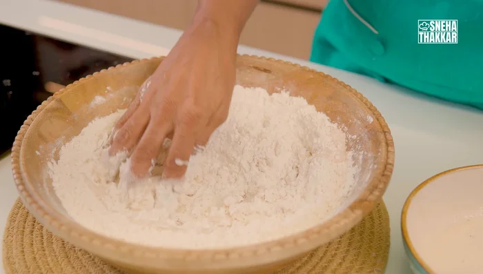 Knead dough: Knead the dough on a floured surface, adding oil gradually, until the gluten develops and the dough is smooth and elastic. Perform the windowpane test to check for gluten development.