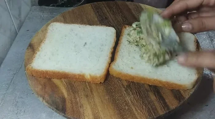 Spread the cheese chilli mixture thinly on bread slices.