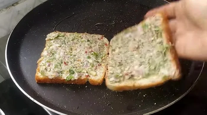 Cook the bread slices in a lightly oiled or ghee-oiled pan until golden brown on one side only.