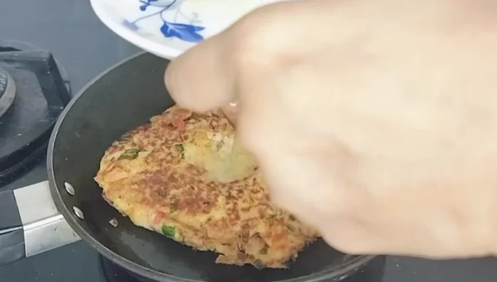 Fill the indentation with the prepared egg yolk mixture. If it spills slightly, don't worry; it will cook.