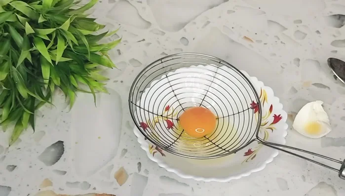 Separate the egg yolk from the white. Add finely chopped onions, tomatoes, and spring onions to the yolk. Gently mix in black pepper powder and salt to taste.