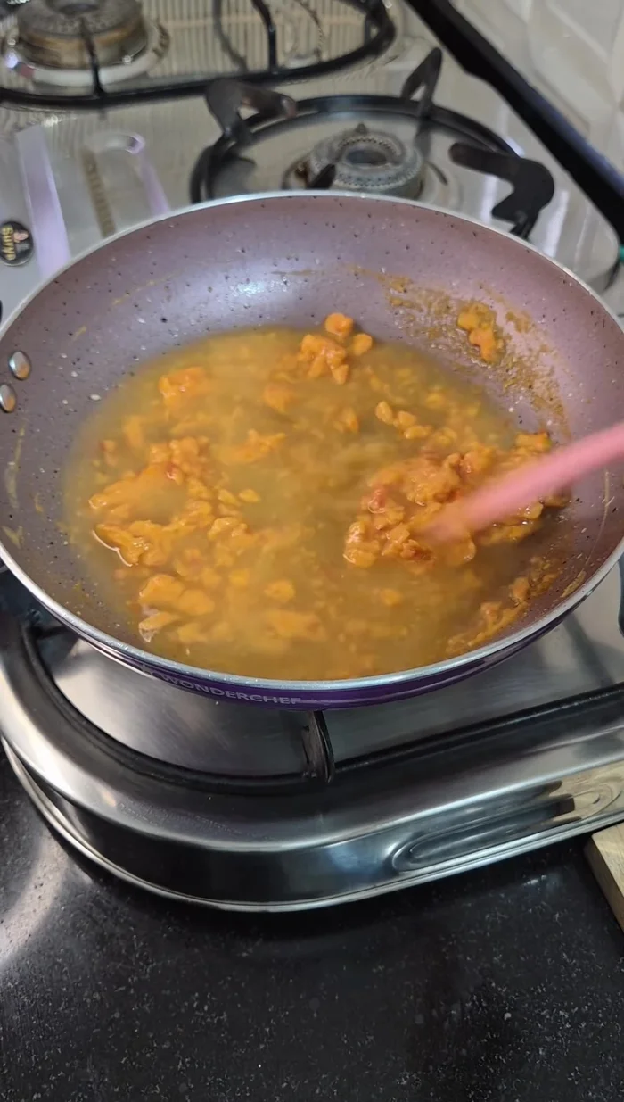 Add chickpea water, turmeric, red chilli, and salt. Cook for 2-3 minutes.
