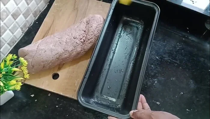 Shape the dough into a loaf and place it in the prepared tin.