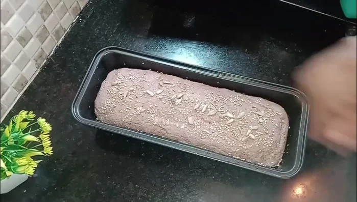 Sprinkle sesame seeds and nuts on the dough.