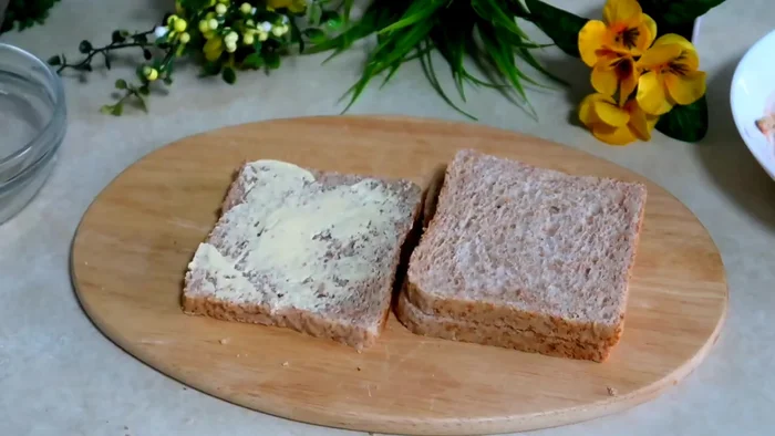 Butter three slices of brown bread.