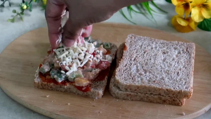 Add the vegetable mixture to the bread, followed by cheese.