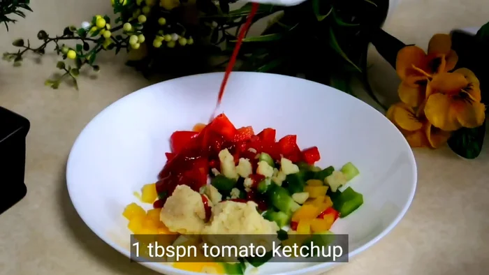 In a bowl, combine capsicum, mashed boiled potatoes, tomato ketchup, mayonnaise, salt, black pepper powder, and oregano. Mix well.
