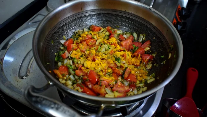 Add salt, turmeric powder, coriander powder, and red chili powder. Mix well.